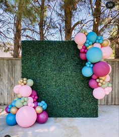 a large letter made out of balloons and grass