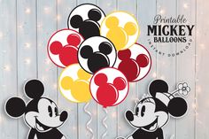 mickey and minnie mouse balloons with lights in the background