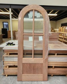 a large wooden window sitting on top of pallets in a room filled with furniture