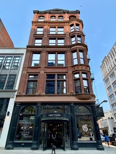 a tall building with lots of windows on the side of it's front entrance