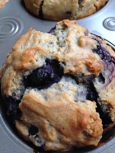 blueberry muffins sitting in a muffin tin