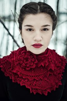 a woman wearing a red scarf and black top