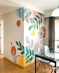 a dining room with a painted wall in the background and wooden flooring on the other side