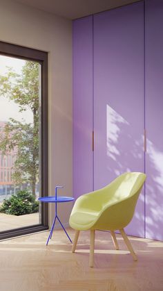 a yellow chair sitting in front of a purple wall