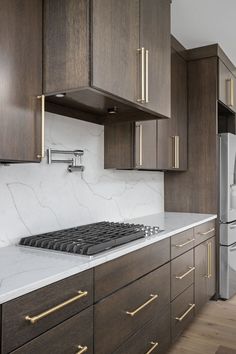 a stove top oven sitting inside of a kitchen next to wooden cabinets and white counter tops