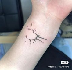 a person's arm with a small tattoo on it that looks like lightning strikes