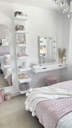 a bedroom with a bed, desk, mirror and shelves on the wall above it