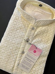 Light Cream Chikankari Work Men's Kurta Pajama Set with full Lucknowi embroidery work on the Kurta on the Front and back side of the Kurta. Kurta comes with a Soft Lining paired with white color cotton bottom/pajama. Kurta is Fully Lined. Very trendy and Classy Looking Mens Wear. Item : Men's Kurta PajamaReady to Wear : YesKurta Color : Light Cream Pajama Color : White Fabric : Georgette Pocket : YesWork : ChikhanKari Embroidery, Fancy ButtonsDisclaimer-For sizing please refer to the Size Chart Luxury Chikankari Embroidered Sherwani For Party, Luxury Chikankari Embroidery Sherwani For Puja, Luxury White Jamawar Kurta, Kurta Pajama With Shawl, Cream Kurta Men, Men Ethnic Wear India, Lucknowi Embroidery, Short Kurta For Men, Mens Ethnic Wear