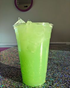 a green drink sitting on top of a table