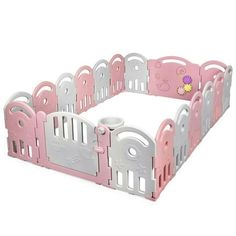 a pink and white baby playpen with lots of gates on it's sides