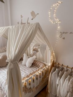 a white canopy bed in a girls room