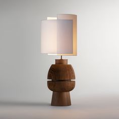 a wooden table lamp with a white shade on it's top and bottom part