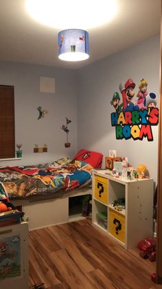 a room with a bed, desk and toy chest in the corner that has mario's bedroom on it