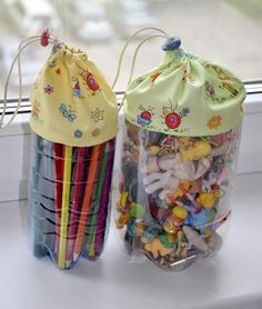 two bags filled with different colored pencils sitting on a window sill