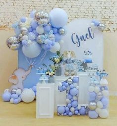 a table with balloons and decorations for a first birthday party or baby's 1st birthday