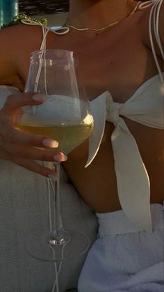 a woman holding a wine glass in her right hand