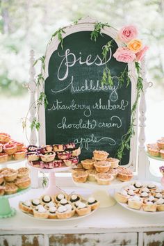 a table topped with lots of desserts and pastries