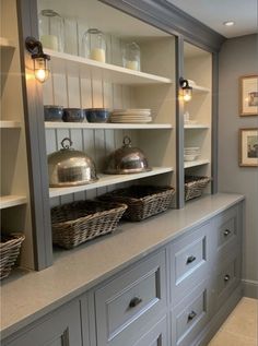 the shelves in this kitchen are filled with pots and pans