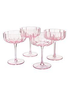 six pink wine glasses sitting on top of each other