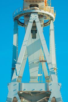 a tall tower with a clock on it's side against a blue sky background