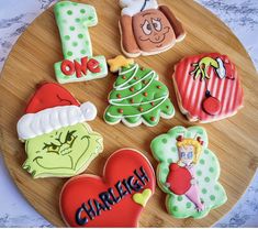 decorated cookies are arranged in the shape of numbers on a wooden platter, including one for christmas and one for dr seuss