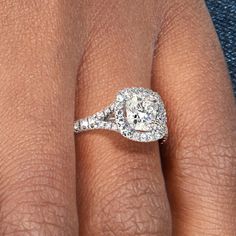 a woman's hand with a diamond ring on her finger and an engagement band