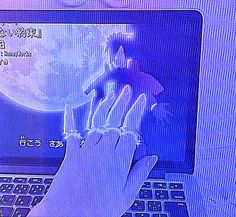 a person typing on a laptop computer with the moon in the backgroup