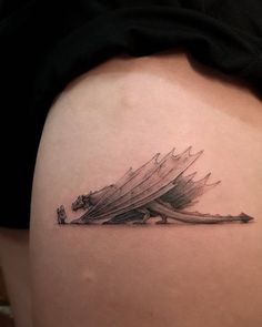 a tattoo on the back of a woman's thigh