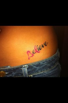 a woman's stomach with the word believe written on it in cursive writing