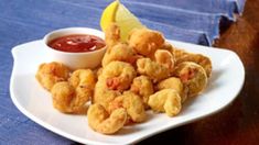 fried food on a white plate with dipping sauce