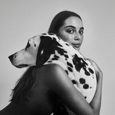 a woman with a dalmatian dog on her back