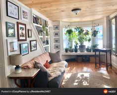 a living room filled with furniture and pictures on the wall