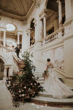 the bride and groom are walking down the stairs