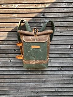 "This pack is constructed out of a British waxed canvas for the corpus in the color burned umber, and olive green heavy weight waxed canvas for the bottom, outside pocket and padded shoulder straps. I made it for everyday use , with padded waxed canvas straps and leather strap with buckle closure and clasp.Roll to close top and large outside pocket. On one side you've got detachable and adjustable leather straps, to carry your jacket on Yogamat This rucksack is fully lined with a blue cotton fab Khaki Waxed Canvas Backpack For Outdoor, Khaki Waxed Canvas Standard Backpack, Khaki Waxed Canvas Backpack, Leather Tutorial, Waxed Canvas Backpack, Canvas Rucksack, Leather Armor, Canvas Backpack, Waxed Canvas