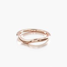 a rose gold ring with two curved sections on the front and back, set against a white background