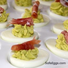 deviled eggs topped with bacon and avocado are ready to be served in the oven