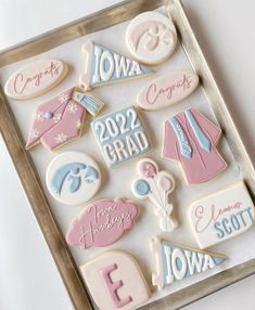 decorated cookies in the shape of letters and numbers are displayed on a cookie sheet that says congratulations