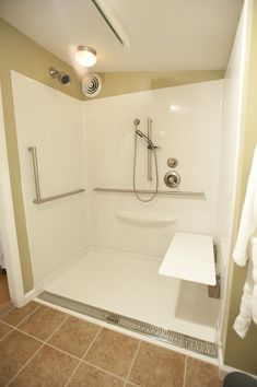 a bathroom with a walk in shower next to a sink