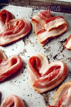 bacon hearts on a baking sheet ready to be cooked