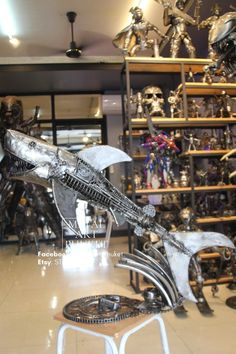 a display in a store filled with lots of different types of metal sculptures and figurines