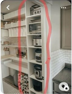 a kitchen with white cabinets and red lines on the wall next to the counter top