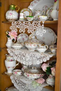 an old china cabinet filled with dishes and cups