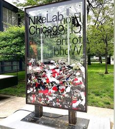 a large sign is in front of a building with trees and grass on the other side