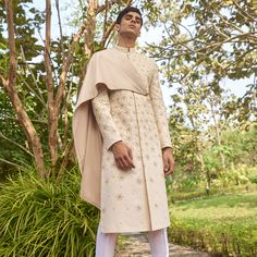 Communicating freely and confidently to keep relationships intact, makes him a #NeotericMan. Timeless silhouette combined with a contemporary twist, the utilitarian Cream Sherwani enhanced with dori and zari placement embroidery and detachable velvet shawl drape is the most ideal choice to make a statement on your special day.  #SarahSandeep #SummerFestive #ContemporaryGrooms #Weddings #IndianWeddings #WeddingSeason #Groomswear #IndianGroom #Bespoke #Menswear Cream Sherwani, Bespoke Menswear, Placement Embroidery, Luxury Menswear, Velvet Shawl, Wedding Outfit Men, Bespoke Suit, Wedding Clothes