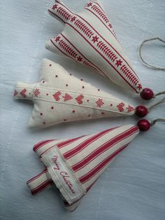 three red and white christmas ornaments on top of a table next to an instagram page