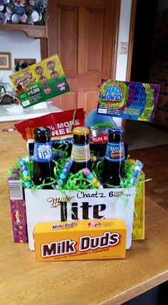 a table topped with bottles of beer and candy bar wrappers on top of it