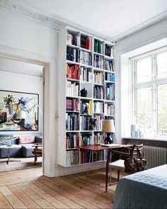 a living room with a book shelf full of books