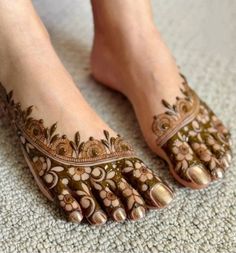 the feet are decorated with henna and flowers