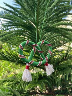 an ornament hanging from a pine tree