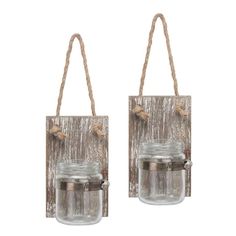 two mason jars hanging from twine rope on the wall, each with a small glass jar in it